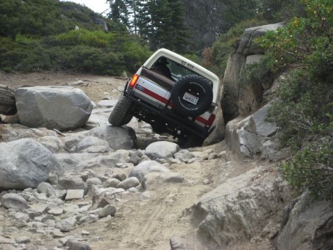 1991 Ford Bronco - This Ford Bronco is tackling a difficult rocky terrain on an off-road trail.