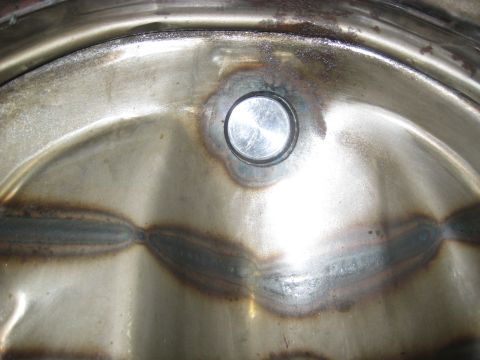 1996 Ford Bronco - This is a close-up view of a metal component, showing signs of welding and a central fastening point.