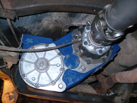 1979 Ford Bronco - Underbody shot of a freshly painted blue transfer case with a bare aluminum bolt-on rear cover/output housing, the driveshaft yoke and U-jo…