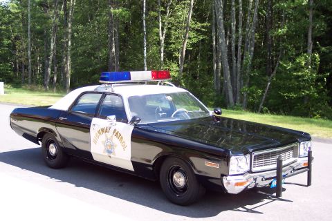 2001 Ford Crown Victoria - This police car features a light bar and "Highway Patrol" markings on the door.
