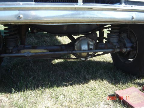 1993 Ford Bronco - Close-up view of the front axle and suspension components of a truck.
