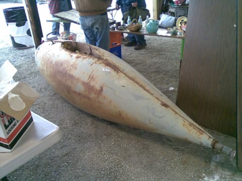 1969 Lincoln Continental - This appears to be a large, rusted metal part, possibly a fuel tank, displayed outdoors.