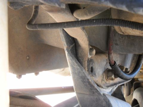 1996 Ford F-250 - Undercarriage view of a vehicle, focusing on frame and suspension parts with visible wiring and hardware.