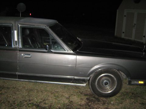 2000 Mercury Grand Marquis - Side profile of a Lincoln Town Car from the 1980s, seen at night.