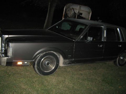 2000 Mercury Grand Marquis - This sedan is parked outside at night on a grassy area.