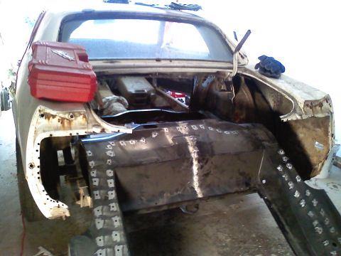 1969 Ford Mustang - The rear of a 1969 Ford Mustang shows extensive bodywork and repairs in progress.