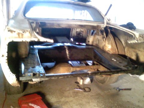 1969 Ford Mustang - The rear frame and trunk area of a car are visible, showing signs of restoration work. The Supermotors.net logo is present in the lower rig…