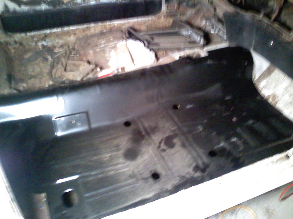 Interior floor pan with new black coating and visible mounting holes
