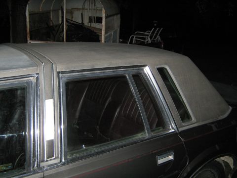2000 Mercury Grand Marquis - The rear passenger side of a long-wheelbase sedan is shown at night, with a greenhouse structure in the background.