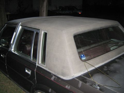 2000 Mercury Grand Marquis - The rear passenger side of a dark-colored sedan is shown at night, with a vinyl-covered roof.