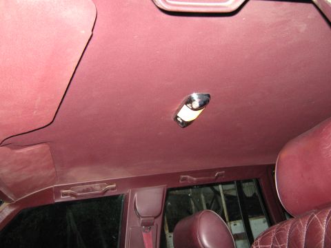 2000 Mercury Grand Marquis - Interior view of a maroon car, showing the headliner, dome light, and rear seating area.