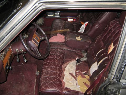 2000 Mercury Grand Marquis - The interior of the vehicle shows significant wear and tear on the seats and upholstery.