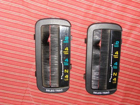 1984 Ford F-250 - Two transfer case shifter assemblies are shown against a red and white striped background.