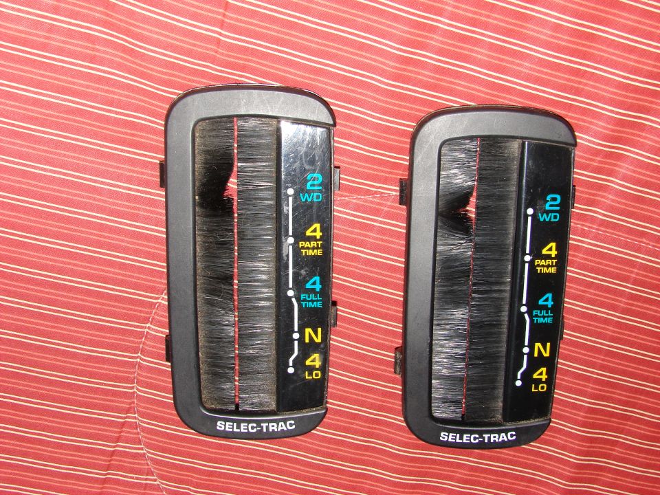 Two black transfer case shifter assemblies with "SELEC-TRAC" text and gear indicators