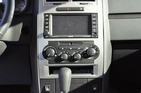 1973 Ford Ranchero - Interior view of a car's center console with infotainment system and climate controls.
