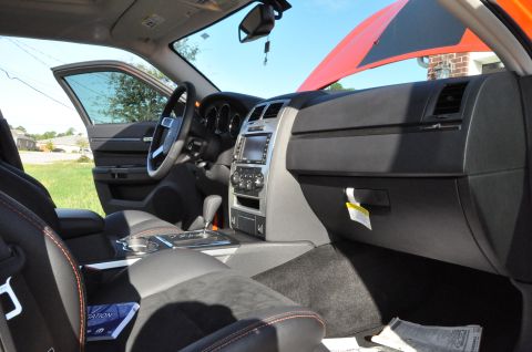 1973 Ford Ranchero - The interior of a modern car is shown with the driver's door and hood open.