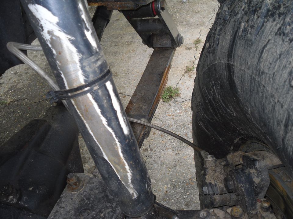 Rear suspension components and tire of a vehicle. Includes shock absorber, leaf spring, and brake assembly