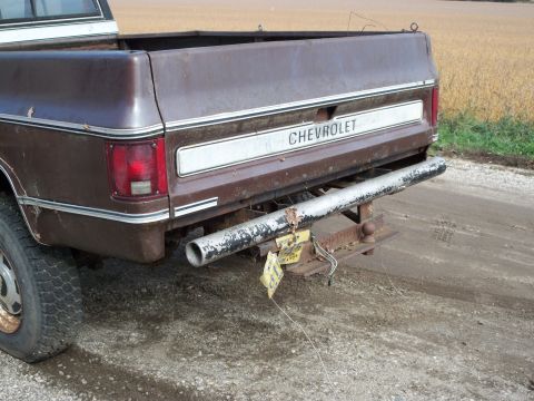 1988 Ford F-150 - This Chevrolet pickup truck has a flat tire and a tow hitch visible on the rear.