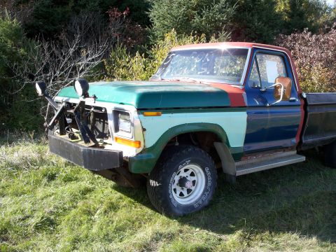 1988 Ford F-150 - This heavily modified pickup truck has a unique, multi-colored paint scheme and extra lights mounted on the bumper.