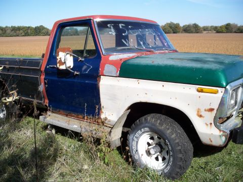 1988 Ford F-150 - This heavily weathered pickup truck shows significant rust and has been repainted with several different colors.