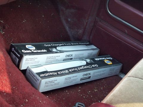 1988 Ford F-150 - Two boxes of NAPA Gas Grande shock absorbers are stored on the floor inside a vehicle.
