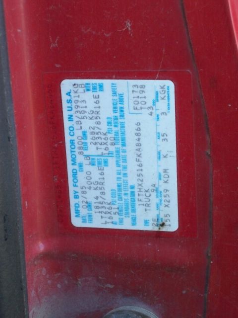 1988 Ford F-150 - Vehicle identification sticker on a red truck door shows a manufacturing date of February 1985.