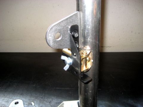 1996 Ford Bronco - Metal bracket assembly with a wing nut attached to a pipe, likely a custom part.