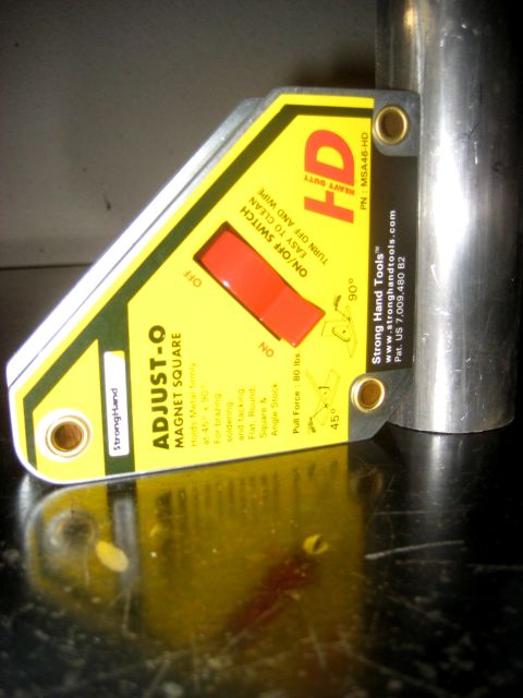 1996 Ford Bronco - A magnetic welding square is shown attached to a metal pipe, ready for use.