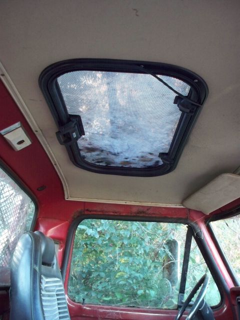 1988 Ford F-150 - Interior view of a red truck, focusing on the sunroof and driver's side.