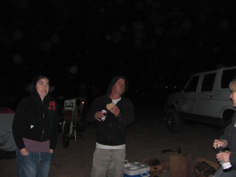 1996 Ford C-350 (Centurion Conversions) - People gather around a campsite at night with a white SUV and dirt bikes visible.