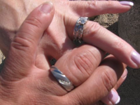 1996 Ford C-350 (Centurion Conversions) - Close-up of two hands intertwined, displaying wedding rings on their fingers.