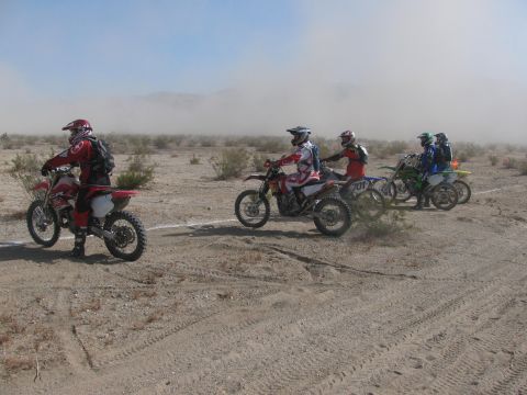 1996 Ford C-350 (Centurion Conversions) - Dirt bike race in progress with riders and bikes on a dusty desert track.