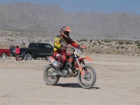 1996 Ford C-350 (Centurion Conversions) - Dirt bike rider in desert landscape with mountains and scrub brush.
