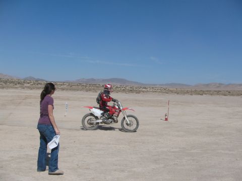 1996 Ford C-350 (Centurion Conversions) - A dirt bike rider is observed in a desert environment with a spectator watching.