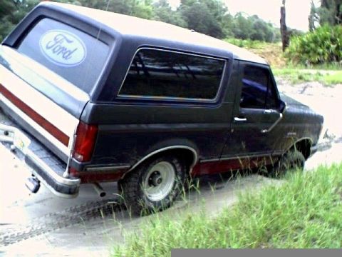 1991 Ford Bronco - This Ford Bronco appears to be from the late 1980s, not a 1991 model, as it is stuck in the sand.