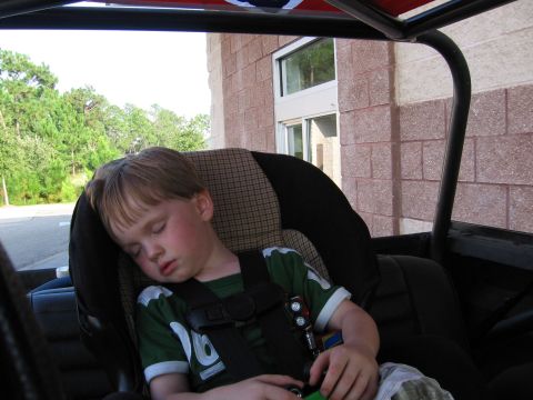 1967 Ford Mustang - A young child is asleep in a car seat, buckled in for a ride.
