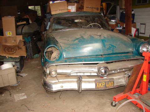 1973 Ford Ranchero - A vintage Ford Custom sits in a cluttered garage, awaiting restoration.
