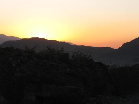 1996 Ford C-350 (Centurion Conversions) - A vibrant sunset casts warm hues over a , mountainous landscape.