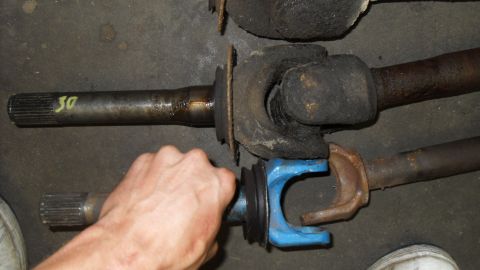 1997 Ford Ranger - Comparison of two driveshaft yokes, one with a blue coating and the other showing rust.