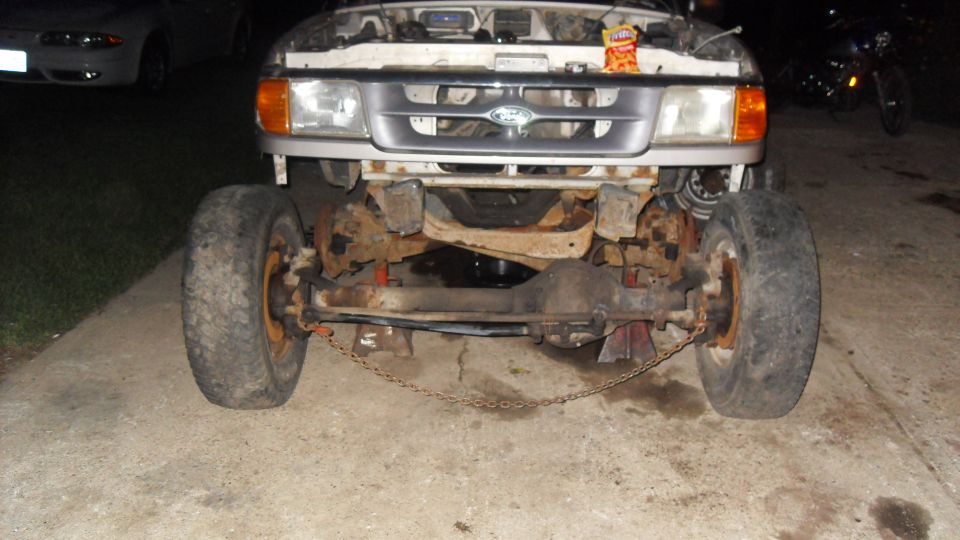 Front view of a 1997 Ford Ranger with the hood up and front wheels removed