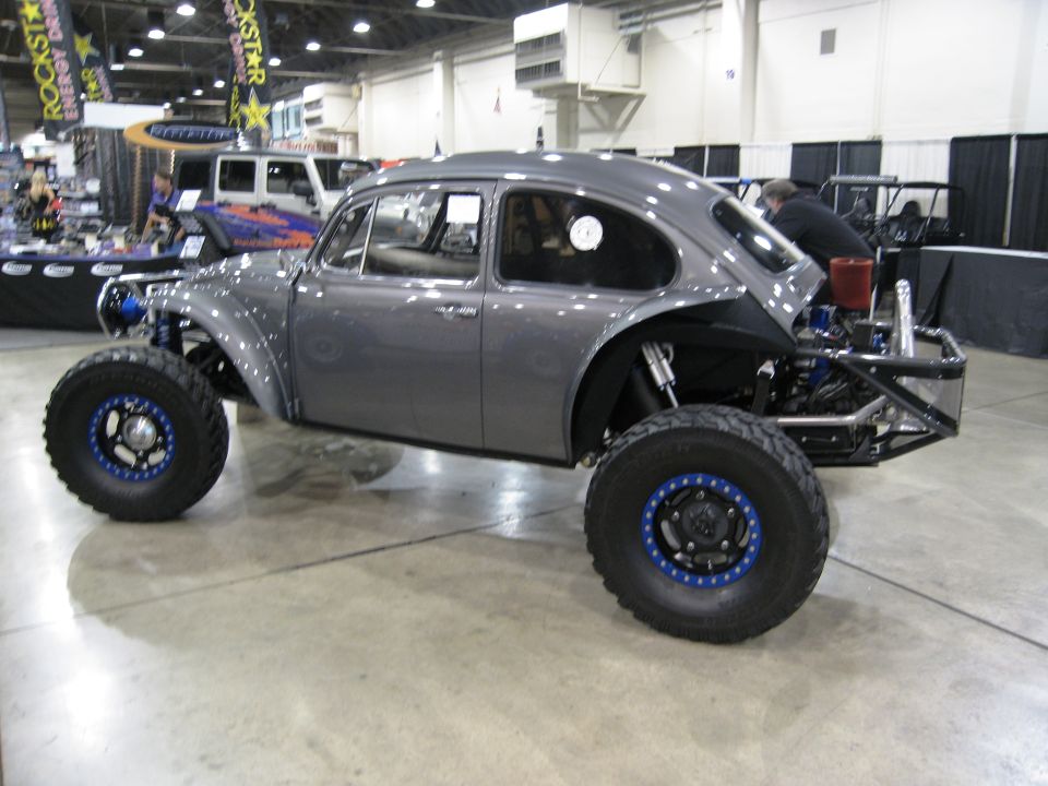 Custom gray VW Beetle dune buggy with big off-road tires and exposed engine