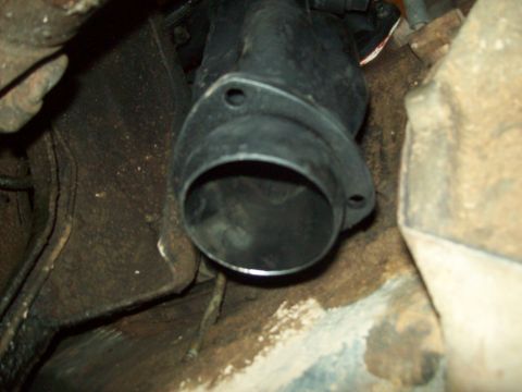 1985 Ford Bronco - Close-up view of an exhaust pipe flange, showing the two bolt holes for attachment.