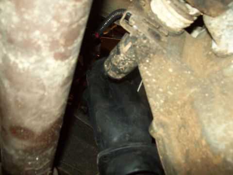 1985 Ford Bronco - Close-up of vehicle undercarriage components, including exhaust and suspension parts.