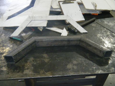 1978 Ford Bronco - Metal fabrication parts and templates are laid out on a workbench, suggesting a custom build in progress.