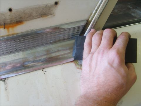 1963 Ford Galaxie - First I spray the top of the panel with WD40 until it is running out the bottom of the trim. Then I use a delrin block and hammer to tap th…