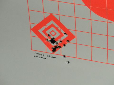 1996 Ford Bronco - A target displays bullet impacts and handwritten notes indicating the date and group size.
