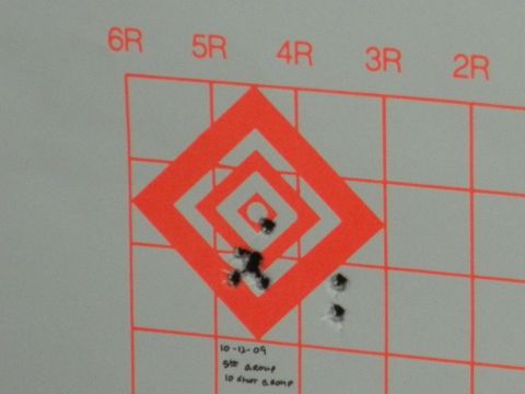 1996 Ford Bronco - A target with multiple bullet impacts and handwritten notes indicating date and shot count.