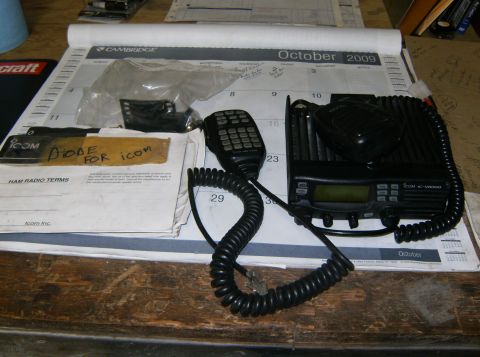 2000 Ford E350 - An Icom IC-V8000 radio and its microphone are displayed on a desk, resting on an October 2009 calendar.
