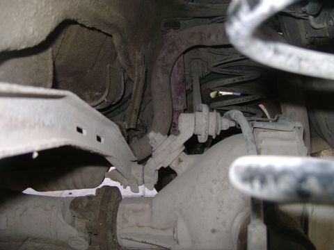 1998 Ford Crown Victoria - Close-up view of the rear suspension system, showing the shock absorber and coil spring assembly.