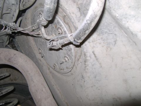 1998 Ford Crown Victoria - Underside view of a vehicle's fuel pump assembly, showing hoses, wires, and the fuel tank.